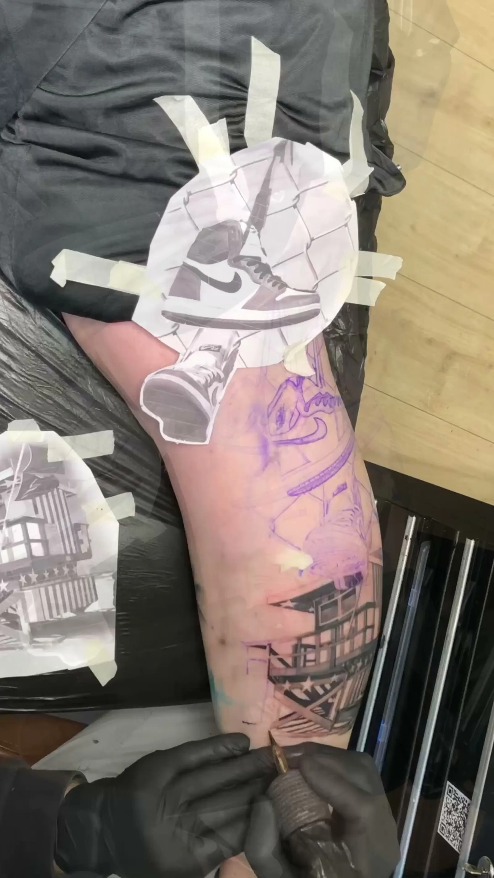Тату-мастер в длинных чёрных перчатках Unigloves за работой в студии Tattoo Highlights