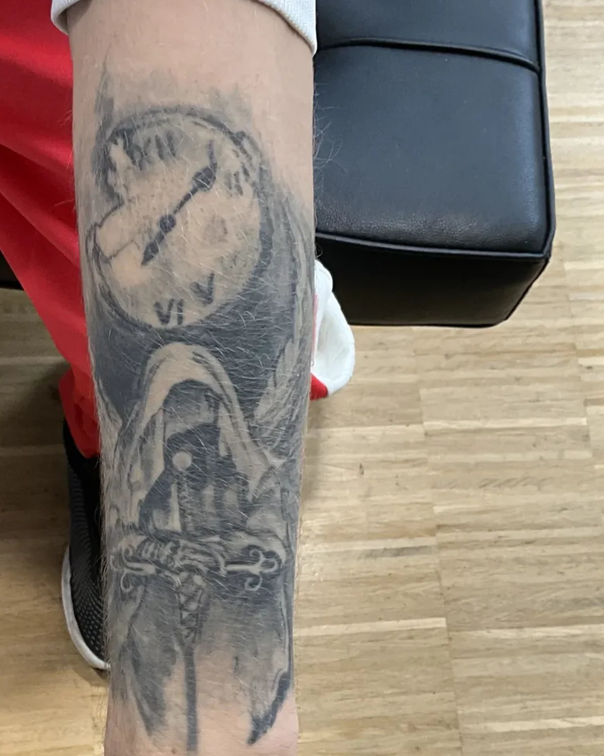 Vorher: verblasstes Uhr- und Sensenmann-Tattoo am Unterarm | Cover-up bei Tattoo-Highlights Hamburg